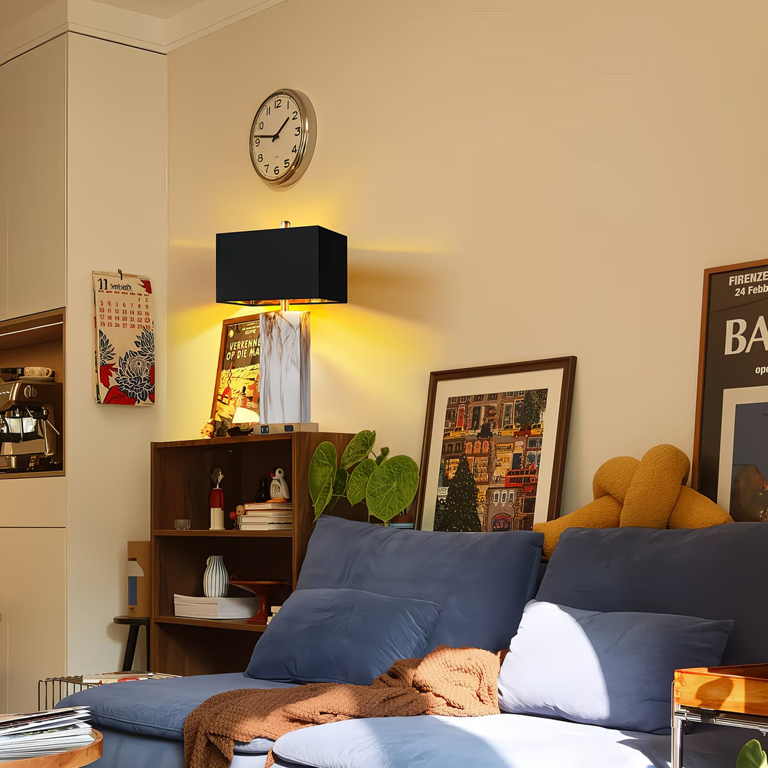 Living room with blue sofa, lamp, and wall clock