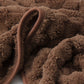 Close-up of brown textured fabric with a focus on texture and color.