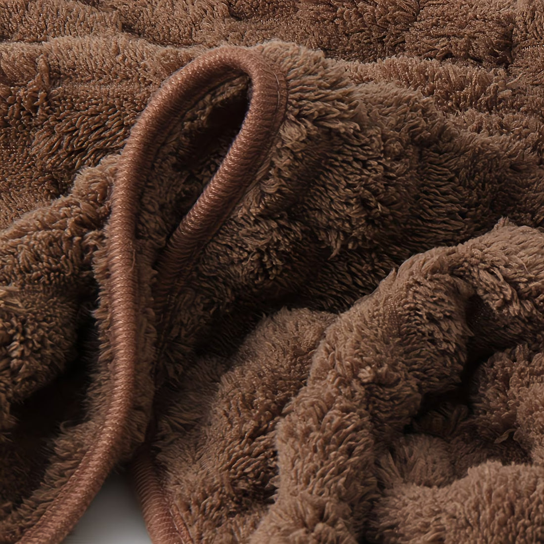 Close-up of brown textured fabric with a focus on texture and color.