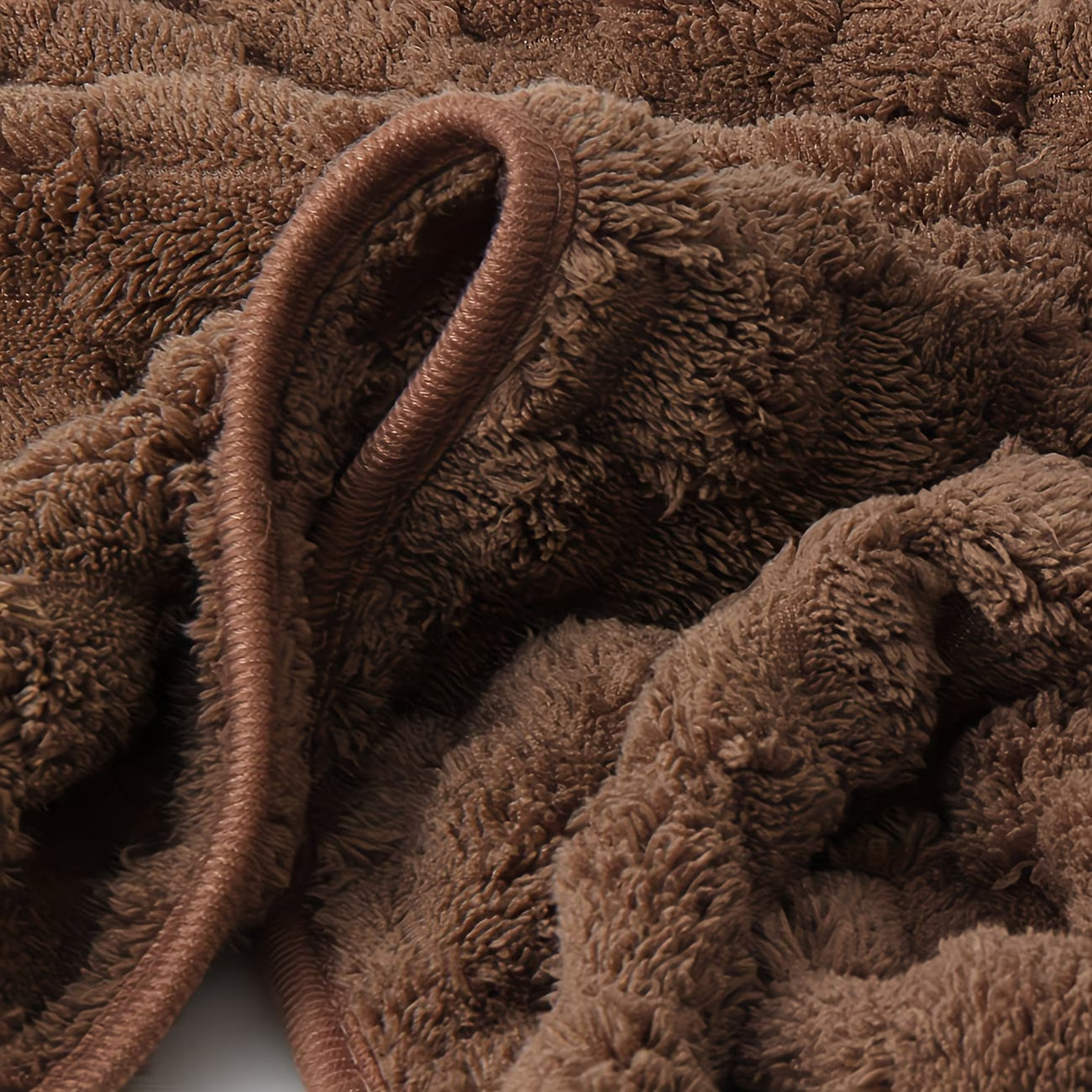 Close-up of brown textured fabric with a focus on texture and color.