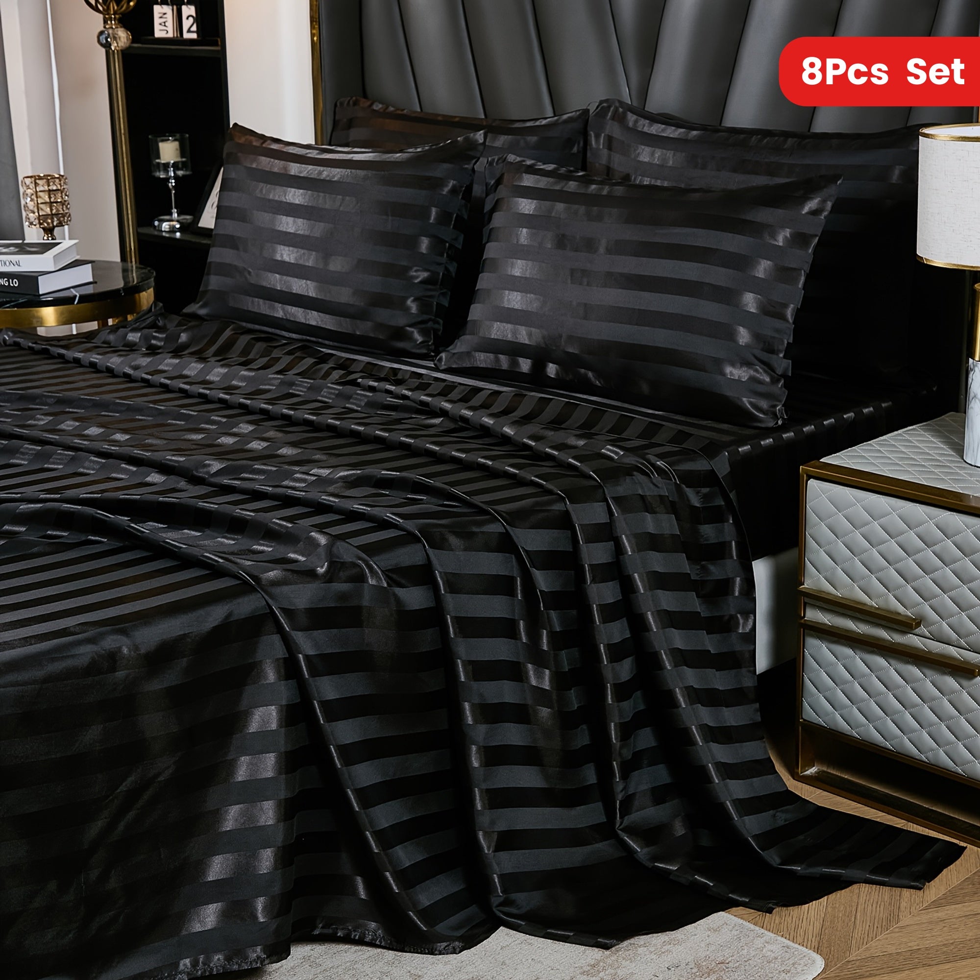 Black striped bedding set on a bed with nightstands in a bedroom setting.