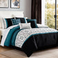 Bedroom with a bed featuring a black, white, and teal comforter.