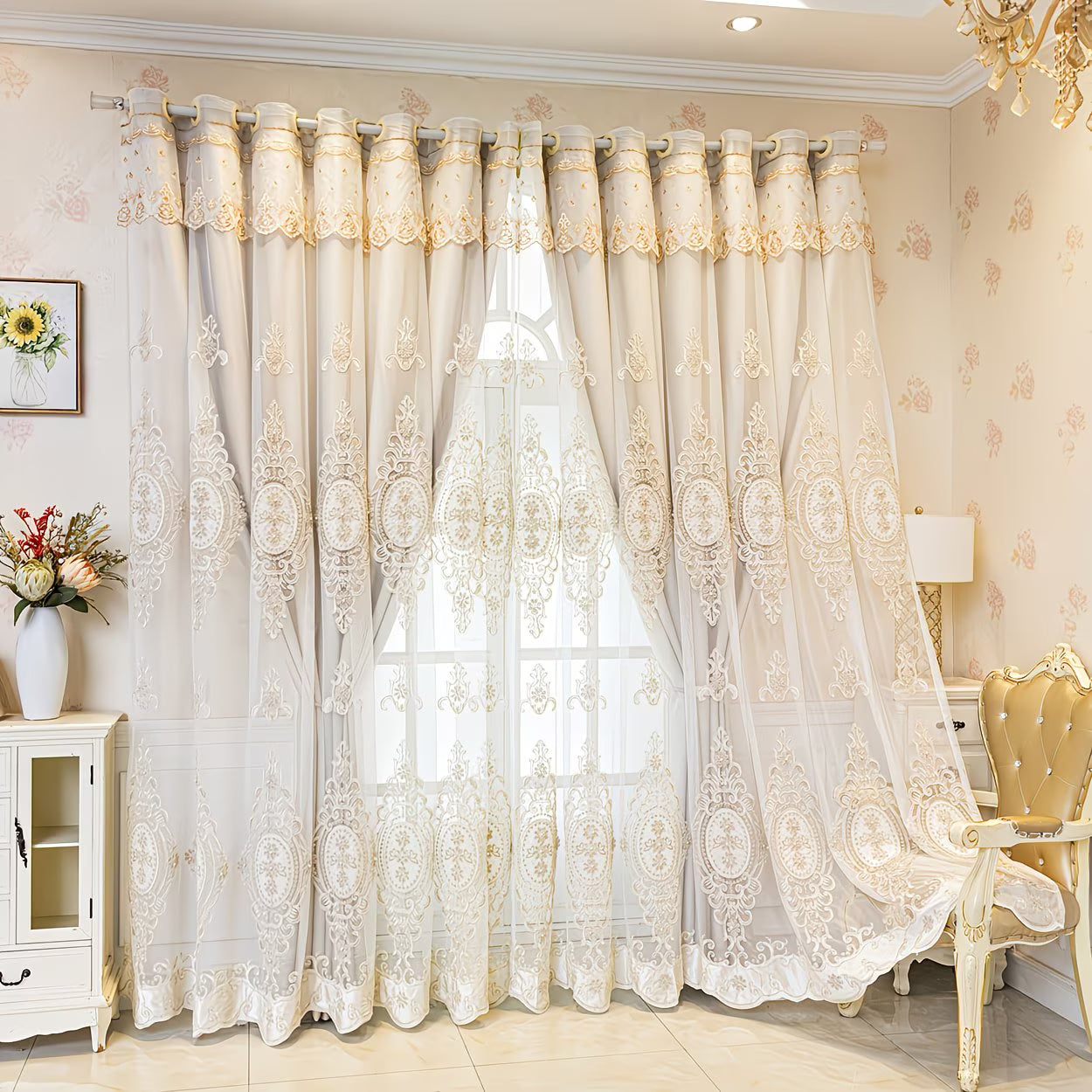 Decorative lace curtains in a stylish room with floral wallpaper and a chandelier.