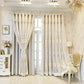 Decorative curtains with intricate patterns in a stylish room with a chandelier and furniture.
