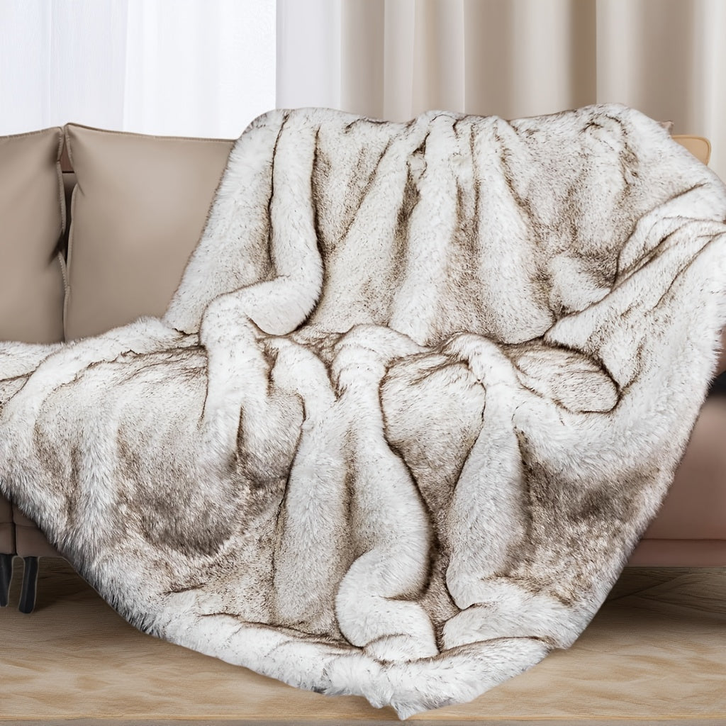 Fluffy beige blanket draped over a sofa in a living room setting.