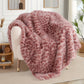 Pink leopard print blanket draped over a chair in a living room setting.