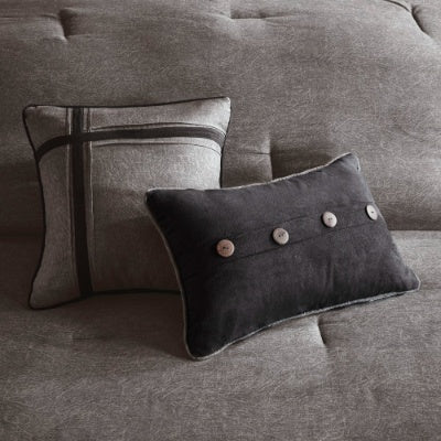 Two decorative pillows on a gray sofa with button details.