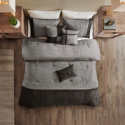 Gray textured comforter set on a bed with wooden headboard and nightstands.