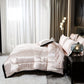 Neatly made bed with white comforter in a modern bedroom setting.