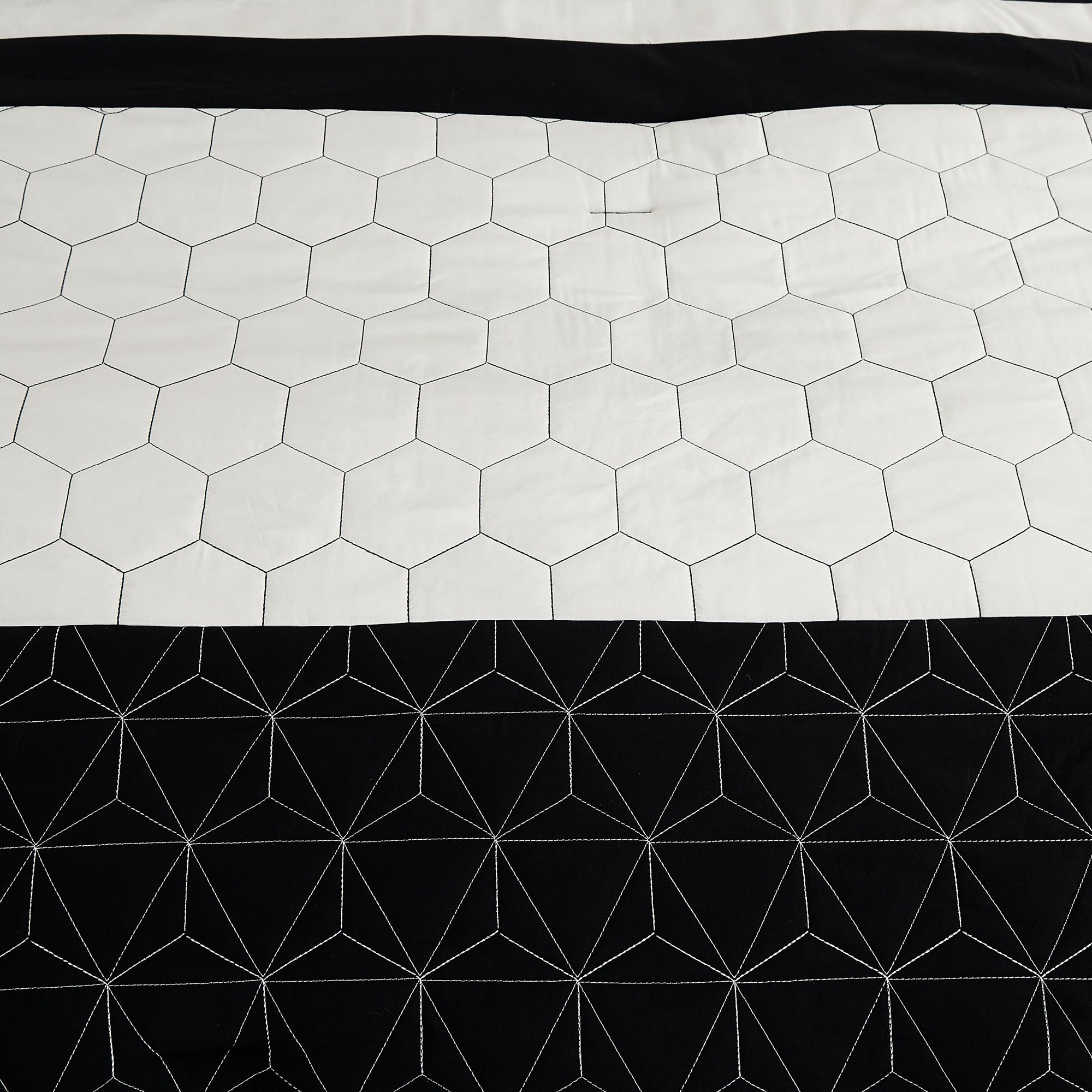 Hexagonal patterned fabric with white hexagons on a black background