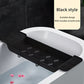 Black bathtub caddy with handles placed on a white bathtub with black tiles in the background.