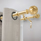 Gold decorative curtain rod with beige curtains on a light gray background