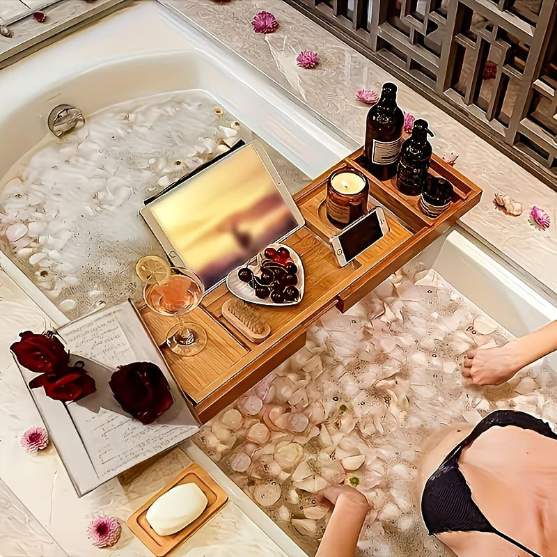 Person relaxing in a bathtub with a wooden tray, tablet, and snacks.