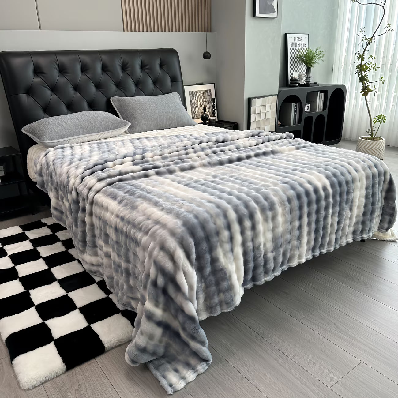 Gray checkered blanket draped over a bed in a bedroom setting.
