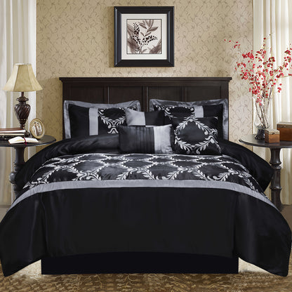 Black and gray patterned bedding set on a bed in a bedroom with decorative elements.