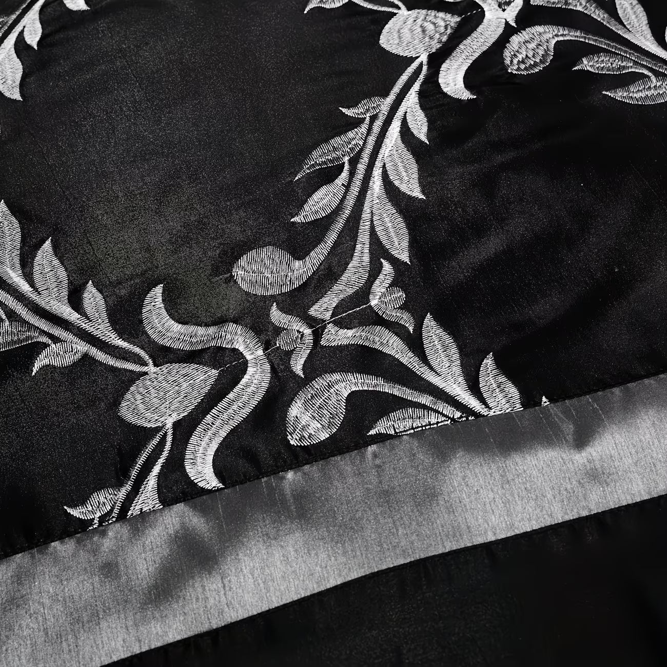 Black fabric with silver floral embroidery