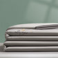 Folded gray blanket with 'always' embroidery on a green background