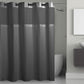 Gray shower curtain with mesh panels in a bathroom setting