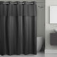Dark gray shower curtain in a bathroom setting with a toilet and sink.