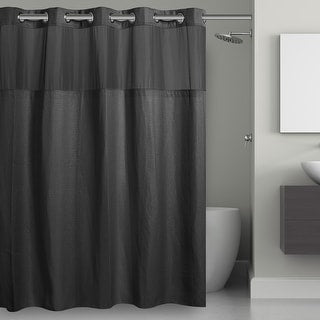 Dark gray shower curtain in a bathroom setting with a toilet and sink.