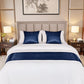 Bedroom with a bed featuring blue and white bedding, nightstands with lamps, and a framed picture on the wall.