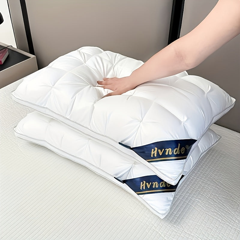 White pillows with Hynde branding on a bed