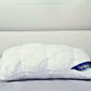 White pillow with a brand logo on a gray background