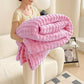 Person holding a pink blanket in a living room setting