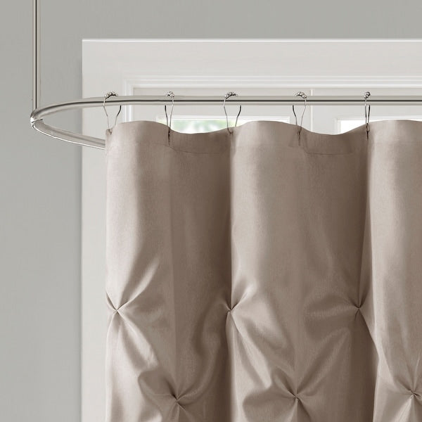 Beige pleated curtain hanging from a rod against a neutral background