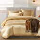 Gold satin bedding set on a bed with a decorative throw blanket in a bedroom setting.