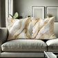 Marble-patterned pillows on a gray sofa in a living room setting.