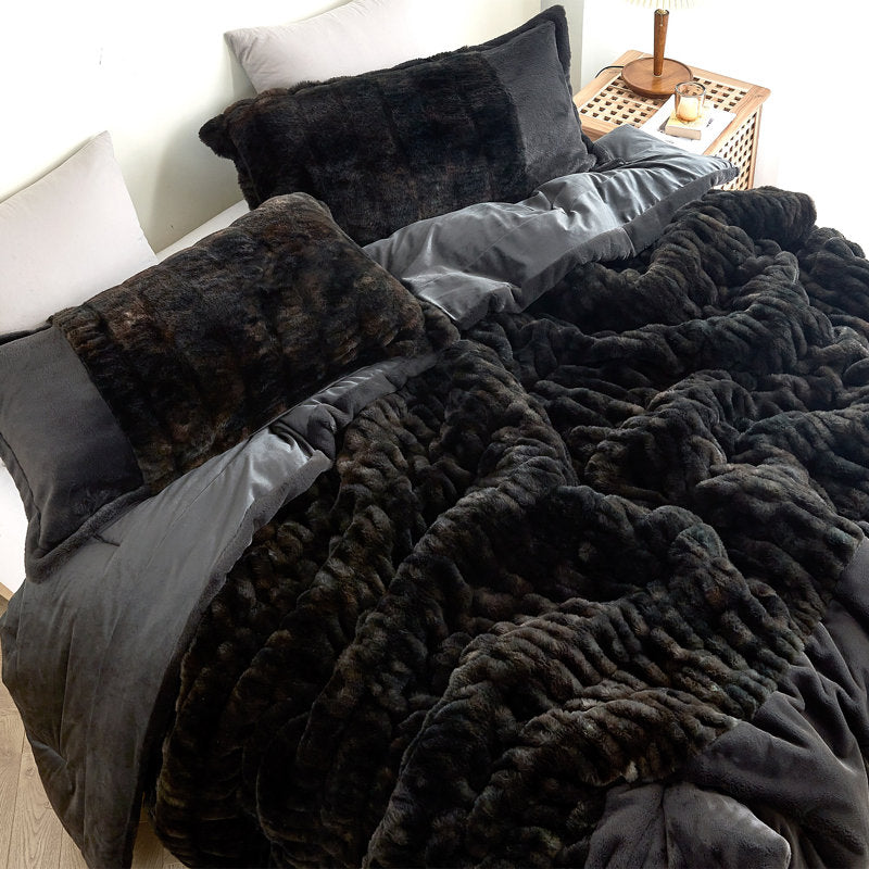Dark faux fur comforter on a bed with pillows in a bedroom setting