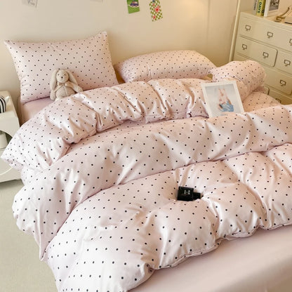 Polka dot comforter on a bed in a bedroom setting