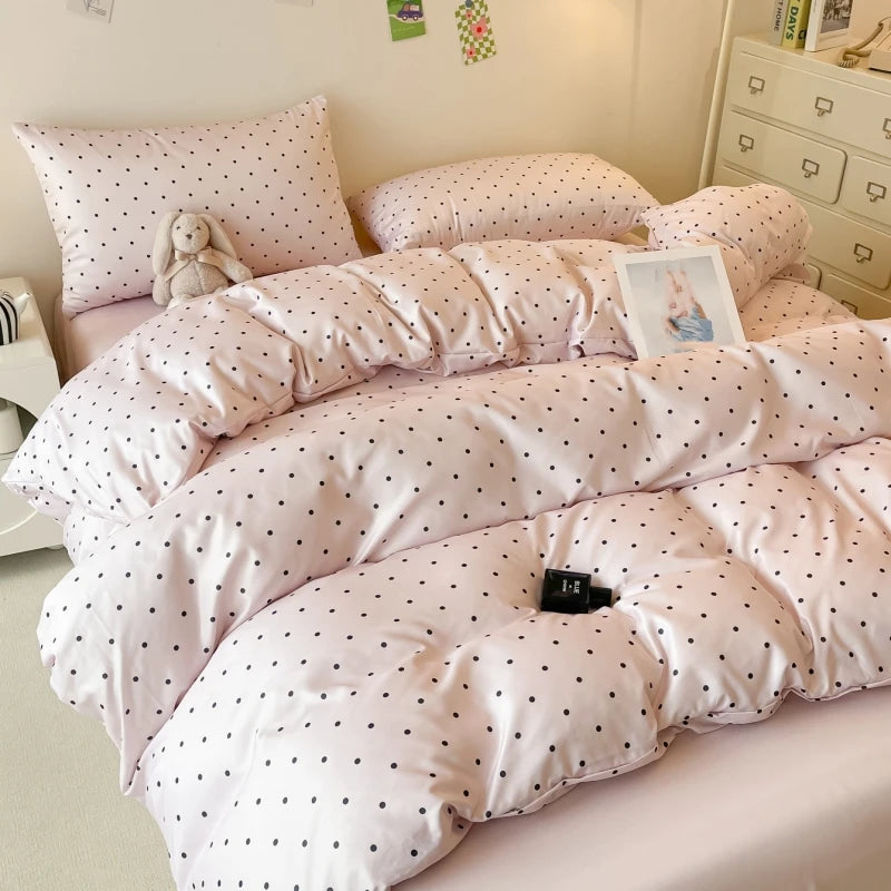 Polka dot comforter on a bed in a bedroom setting