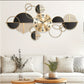 Decorative wall clock with geometric design on a white wall above a sofa.