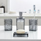 Bathroom accessories set with soap dispenser, toothbrush holder, and soap dish on a white surface.