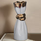 Decorative vase with metallic top on a neutral background