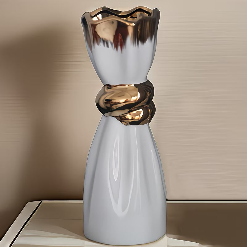 Decorative vase with metallic top on a neutral background
