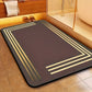Decorative bath mat with gold stripes on a bathroom floor.