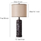 Table lamp with decorative base and beige shade, showing dimensions on a white background
