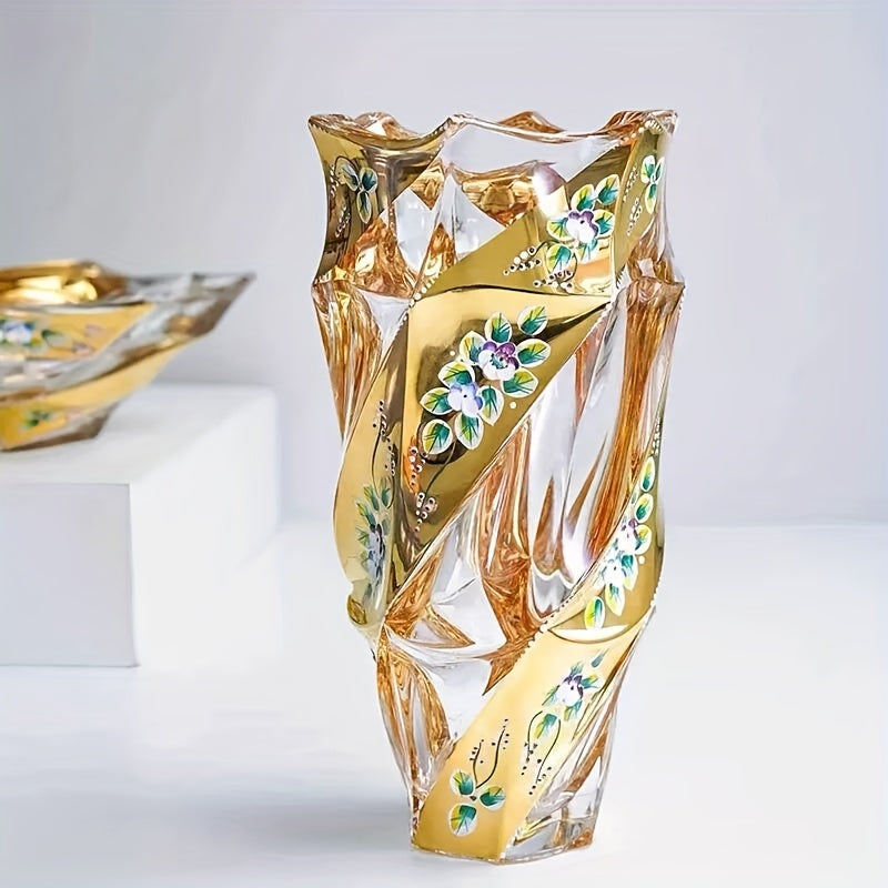 Decorative glass vase with gold and floral patterns on a white background