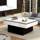 Modern living room with a white and black coffee table, books, and decorative items.