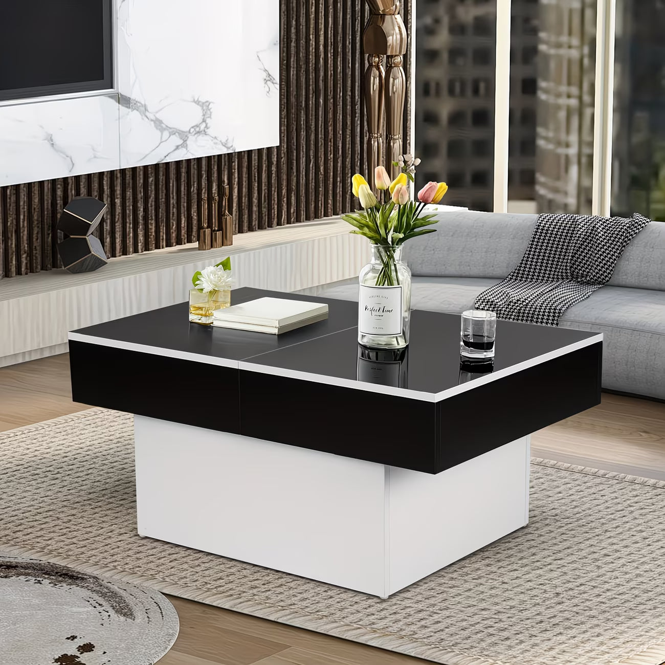 Modern living room with a black and white coffee table, sofa, and decorative elements.
