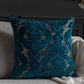 Decorative blue pillow with intricate patterns on a sofa.