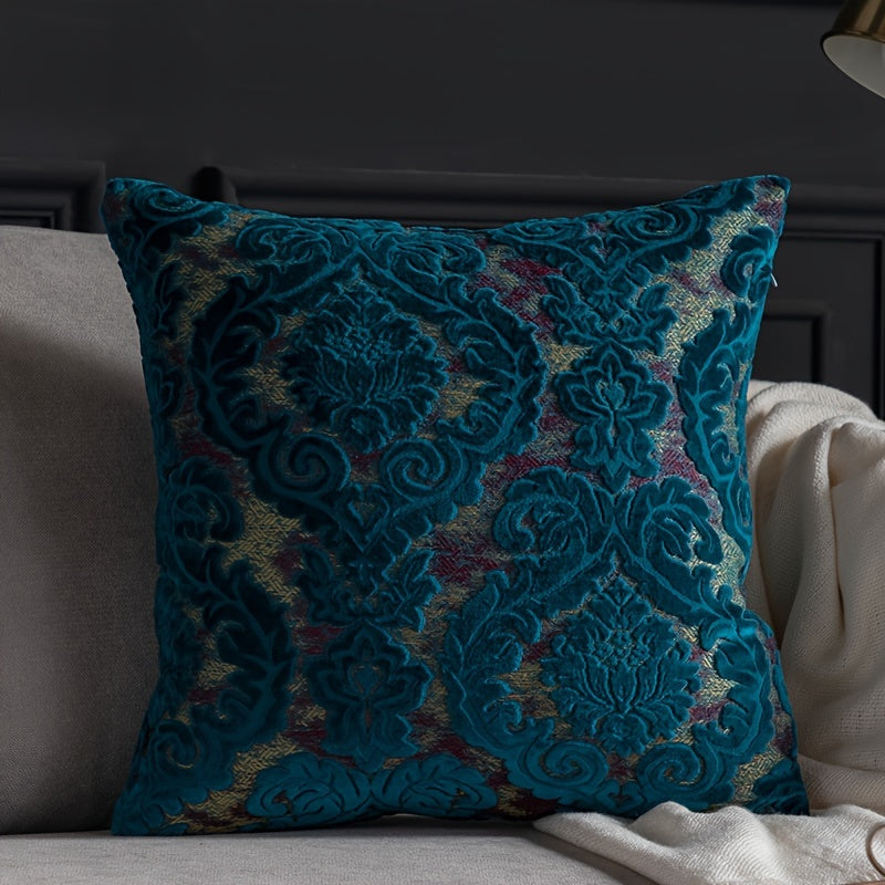 Decorative blue pillow with intricate patterns on a sofa.