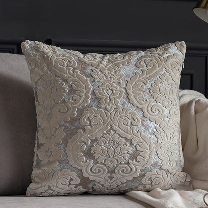 Decorative pillow with intricate lace pattern on a couch.