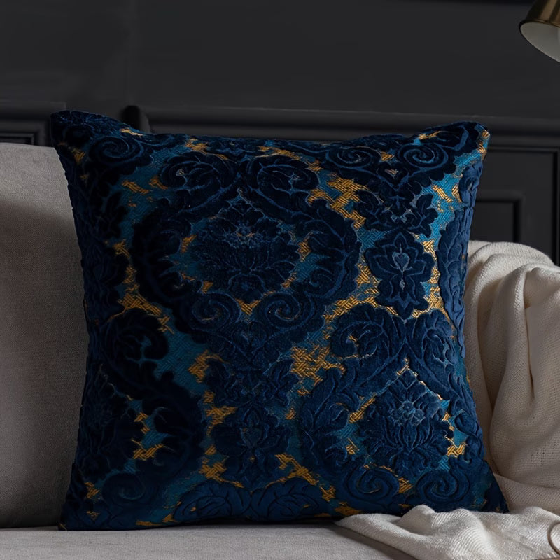 Decorative blue and gold pillow on a sofa