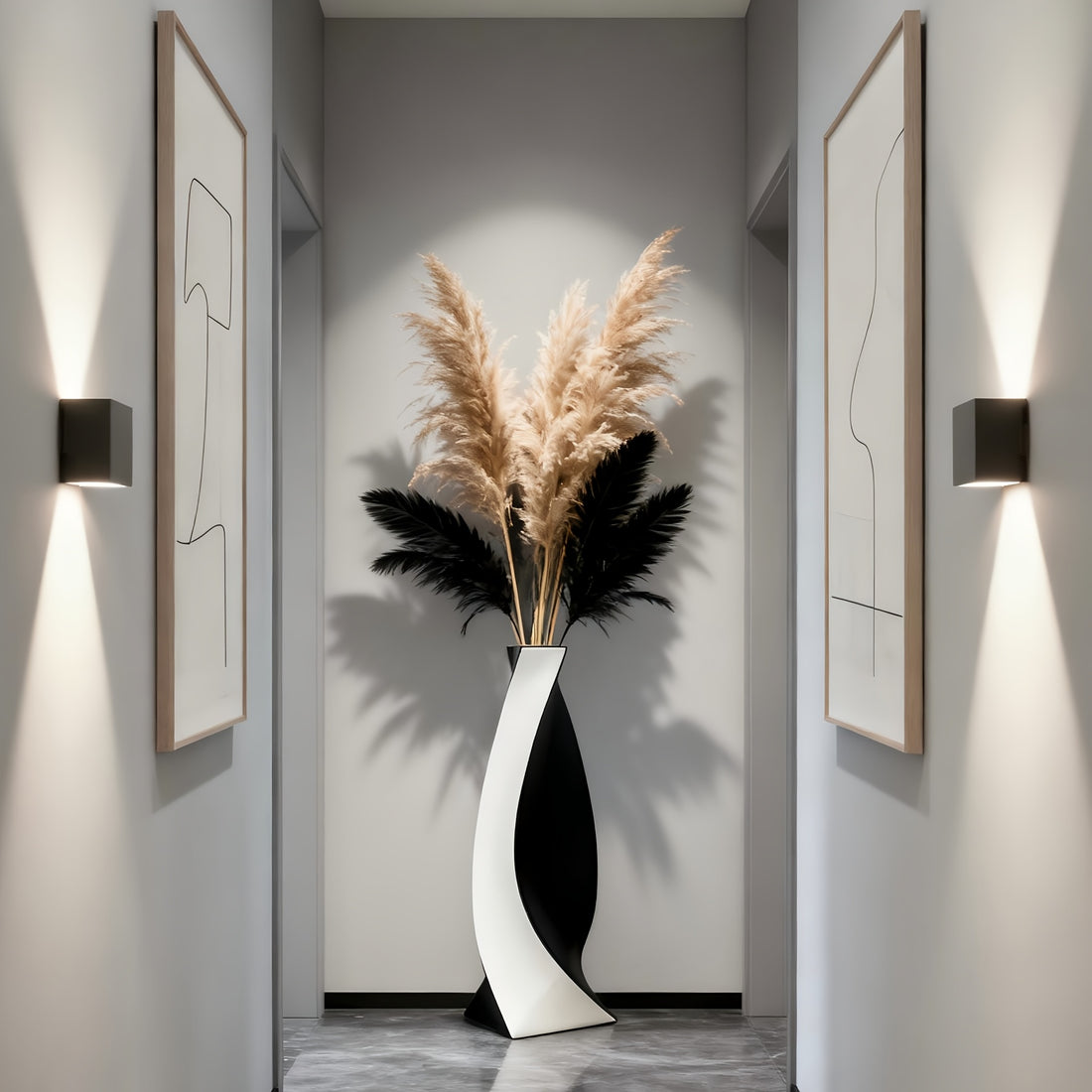 Modern interior with a vase of pampas grass and abstract art on gray walls.