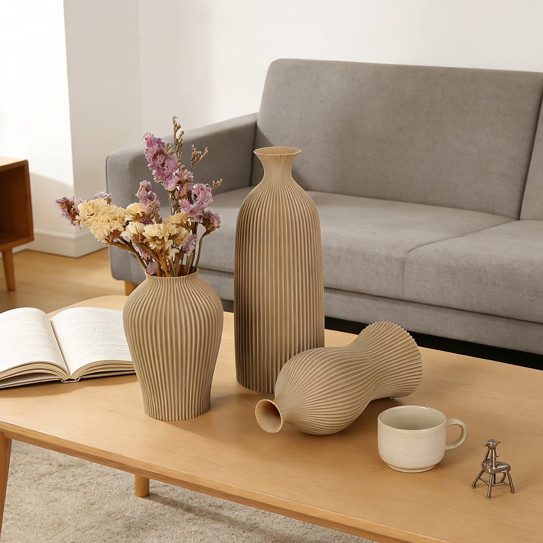 Decorative vases and a cup on a coffee table in a living room setting.