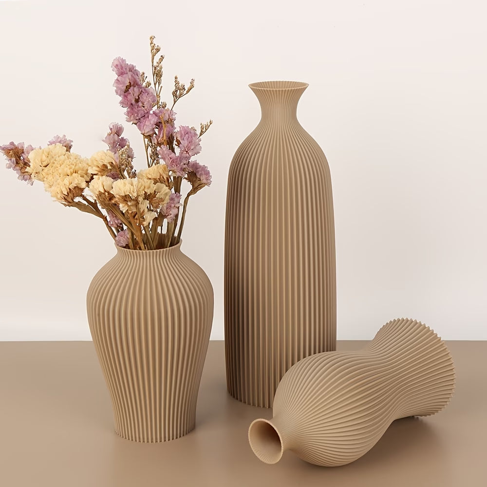 Three beige textured vases on a light brown surface with a plain background